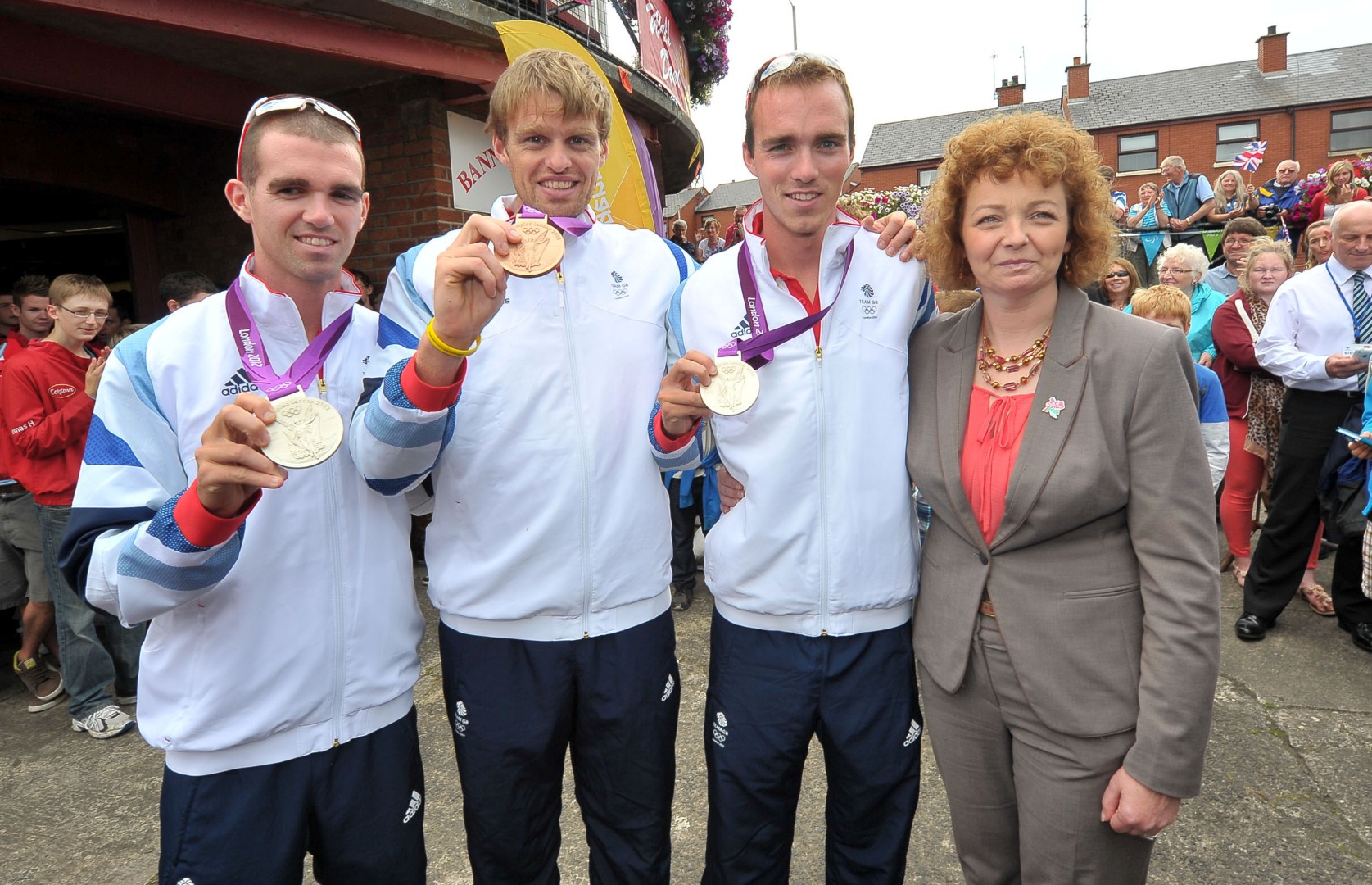 Alan Lewis - PhotopressBelfast.co.uk         15/8/2012
Mandatory Credit - Picture by Justin Kernoghan
A heroes welcome home from Bann Rowing Club for Olympic Medalists (L-R) Richard Chambers,  Alan Campbell  and Peter Chambers (Pictured Sports Minister CarÃ¡l NÃ­ ChuilÃ­n)  - Northern Ireland's Olympic medal-winning rowers are receiving a heroes' welcome in their hometown of Coleraine.Team GB rowers Richard and Peter Chambers took silver in the lightweight fours, while Alan Campbell won a bronze in the single sculls.They have returned to Bann Rowing Club where they honed their rowing skills.Sports Minister CarÃ¡l NÃ­ ChuilÃ­n said their "achievement really does transcend sport and serves as an inspiration to us all".The celebrations will continue with an appearance in the town centre at about 15:00 BST.The three men were cheered by supporters at Belfast City Airport as they arrived back in Northern Ireland on Wednesday morning.